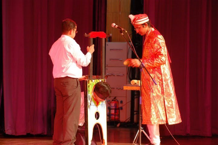 Magician Philip performing Head Chopper on Stage